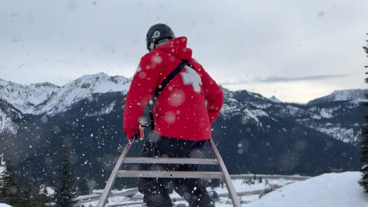 a ski patroller running a sled down the mountain