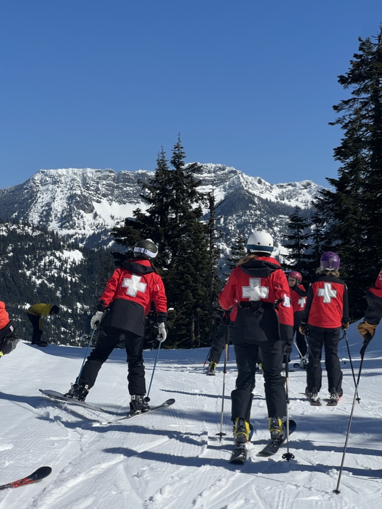 ski patrollers skiing in a group