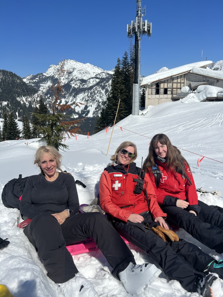 the women of ski patrol sitting together